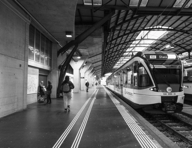 a black and white po of a subway train pulling into a station