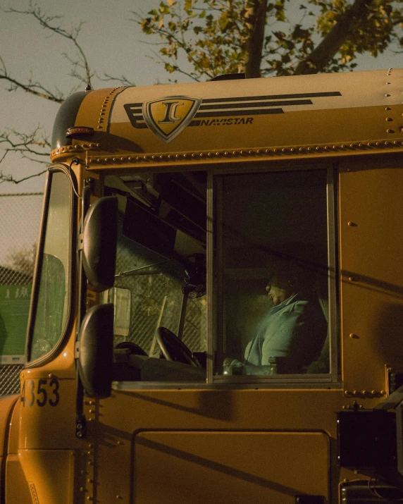 a truck driver looks out the window of his truck