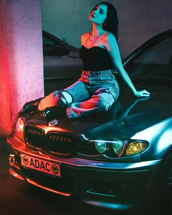 a woman sits on top of a car