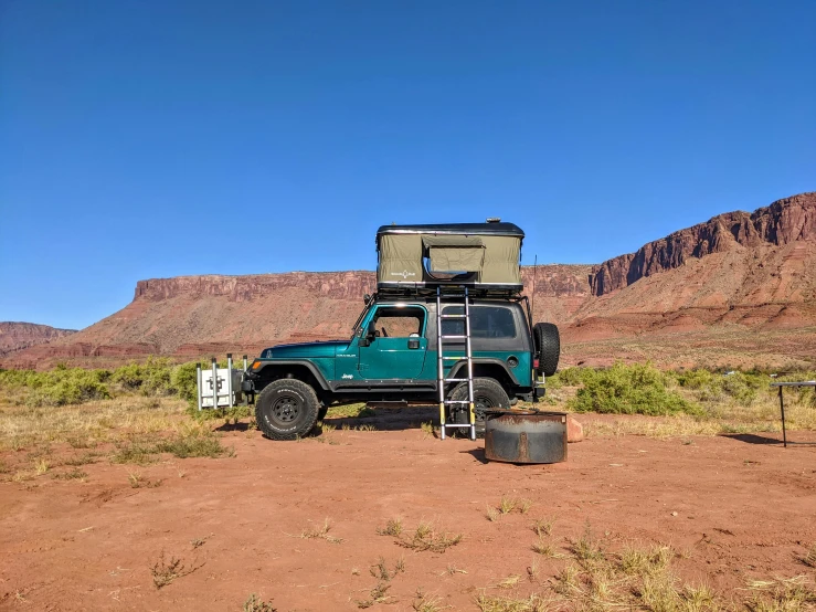 a pick up truck with a ladder to take off and a seat on the back