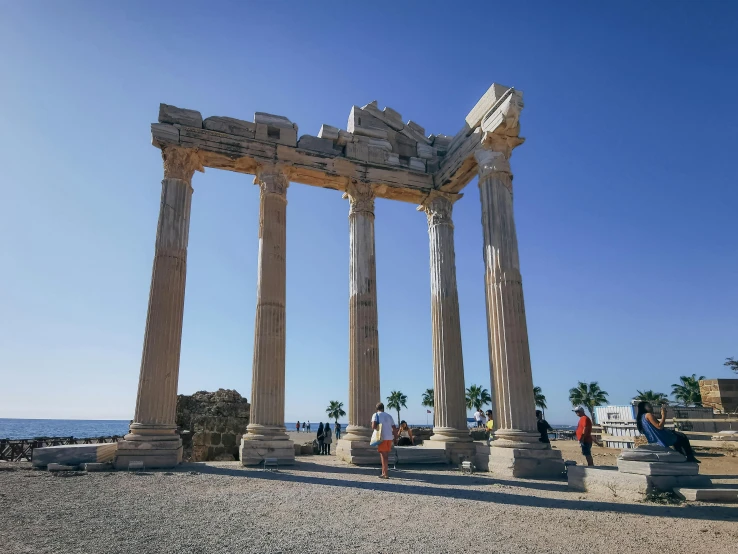 a number of pillars on a rocky beach