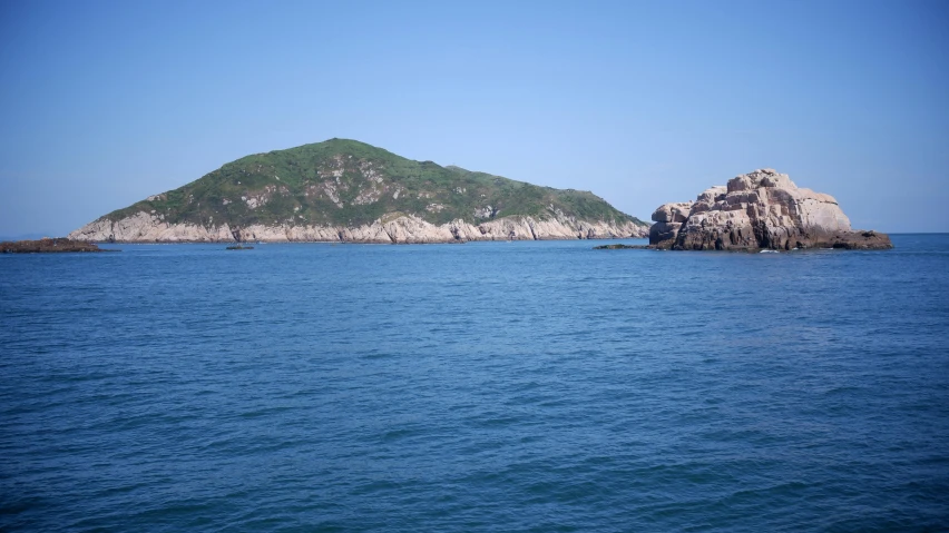 an island surrounded by several smaller islands and small rocks