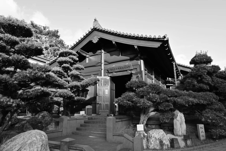 black and white pograph of the exterior of an oriental - styled temple