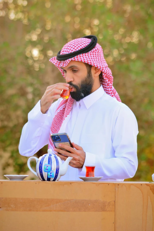 a man in a headscarf looking at his cell phone