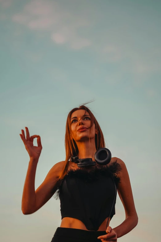 a girl holding a camera up in the air