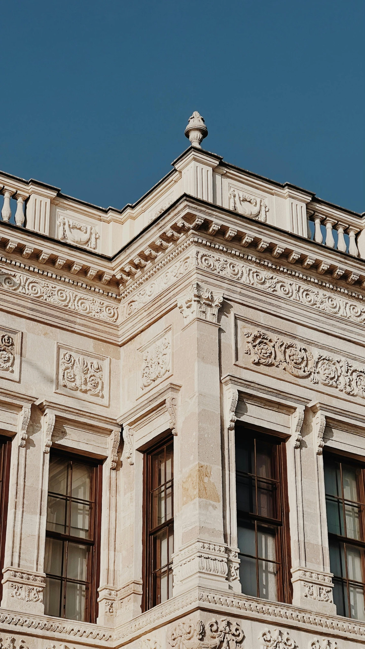 the building's large windows are adorned with intricate carvings