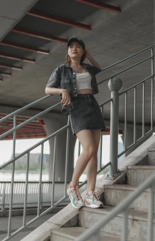 a woman standing on a stairwell next to stairs