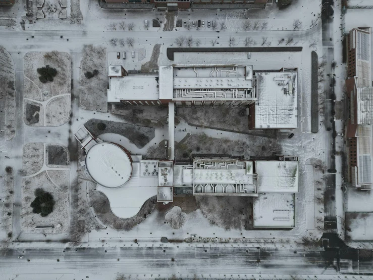 an aerial po of a building next to a parking lot