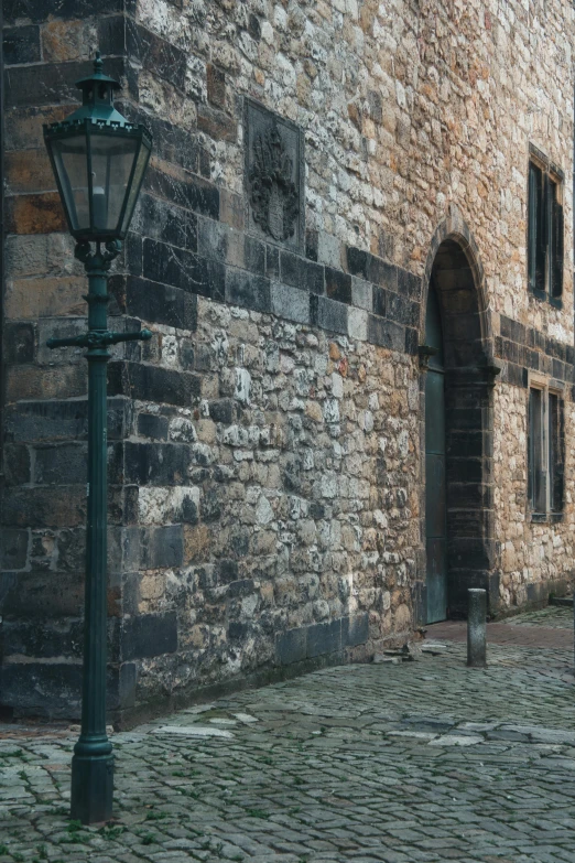 the stone wall of a medieval looking building