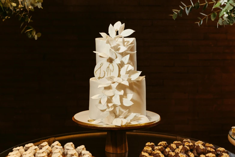 the wedding cake has several pastries next to it