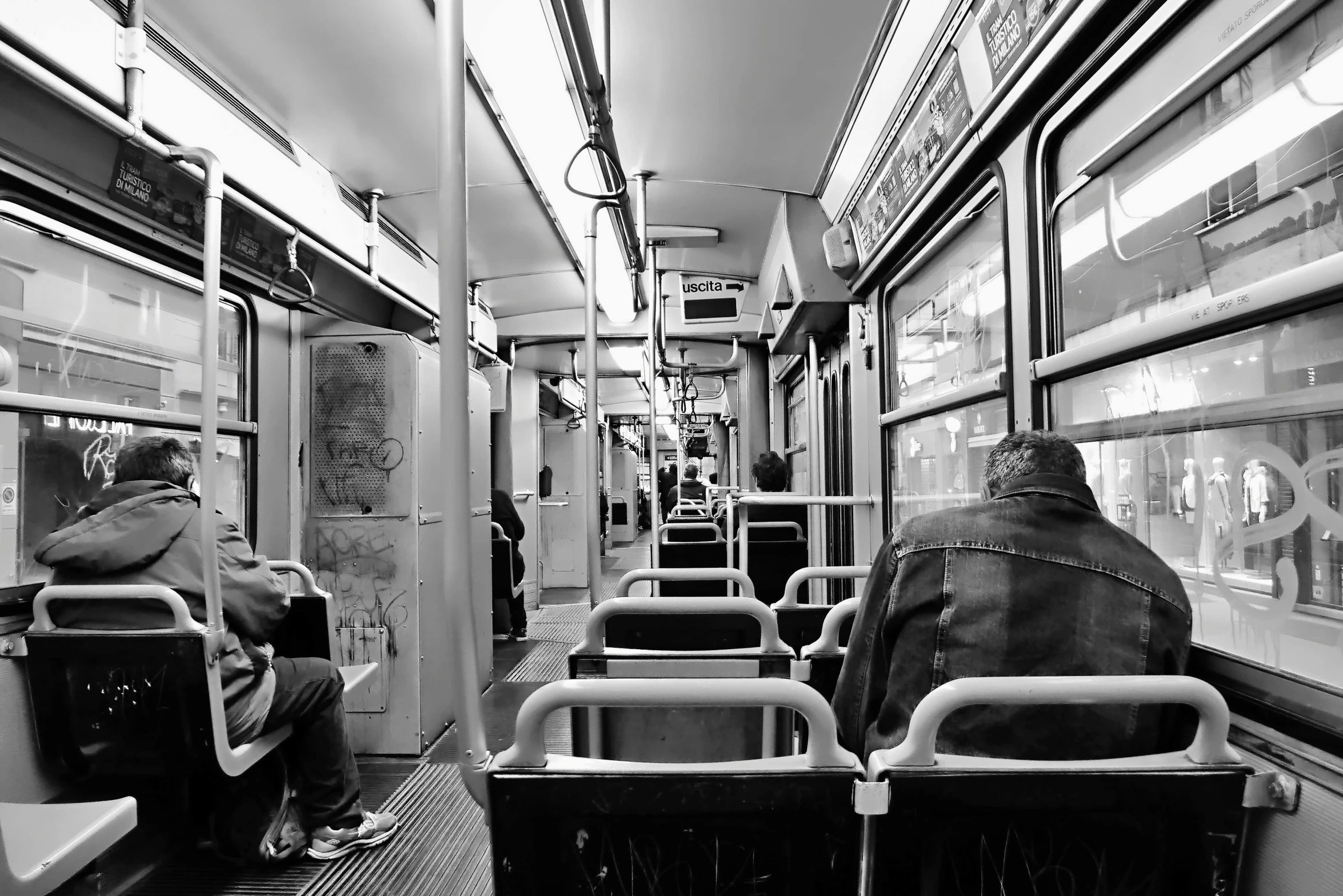 black and white pograph of a person on a train