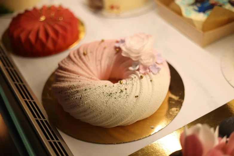 a white cake with pink icing and flowers