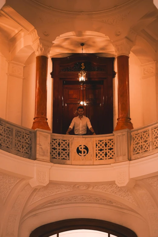 a person sitting in a room in front of a large door