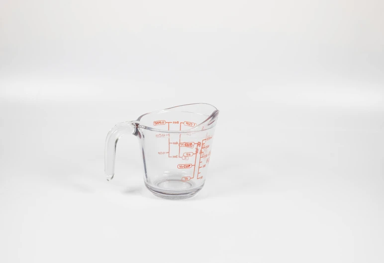 measuring jug on white surface with blank back