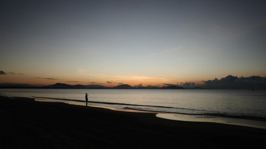 a person standing on a beach during the day