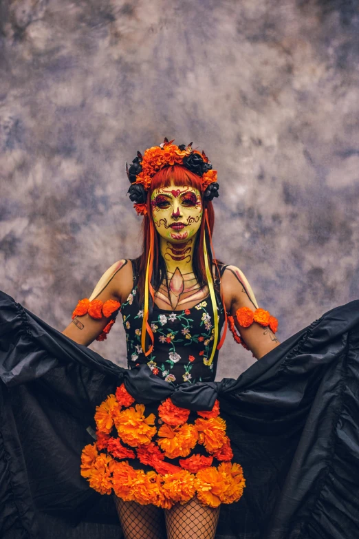 a girl dressed up with orange decorations and black ruffles