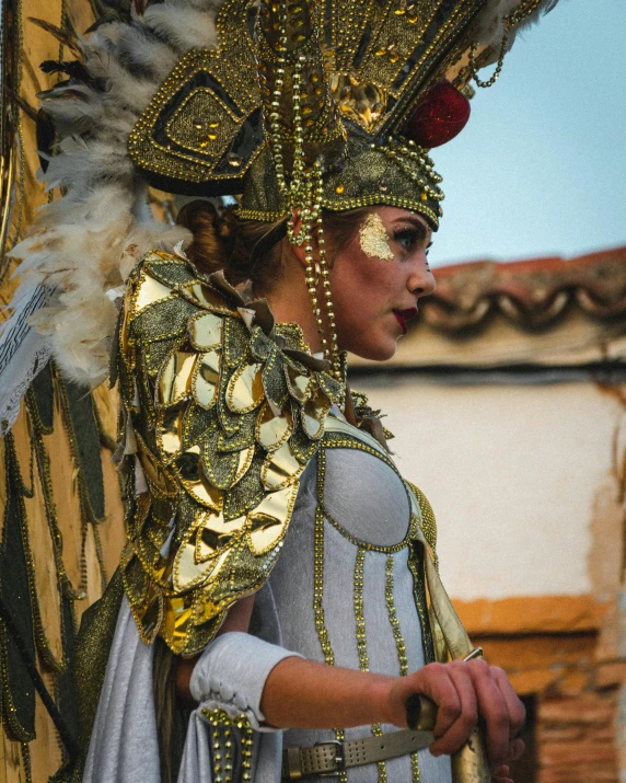 an image of the face and body of a woman wearing a head piece