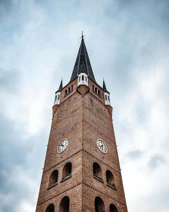 a clock tower that has a weather vein on it