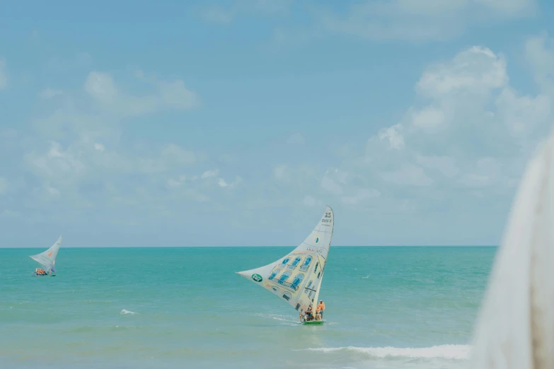 a person windsurfing in the middle of an ocean