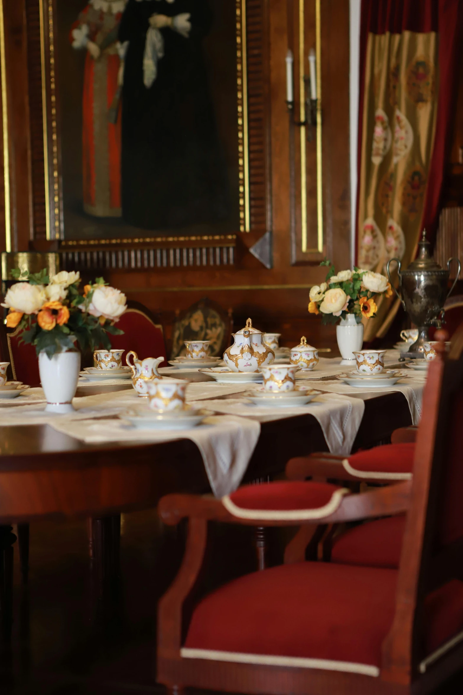 an elegant setting of table with flowers and teacups on it