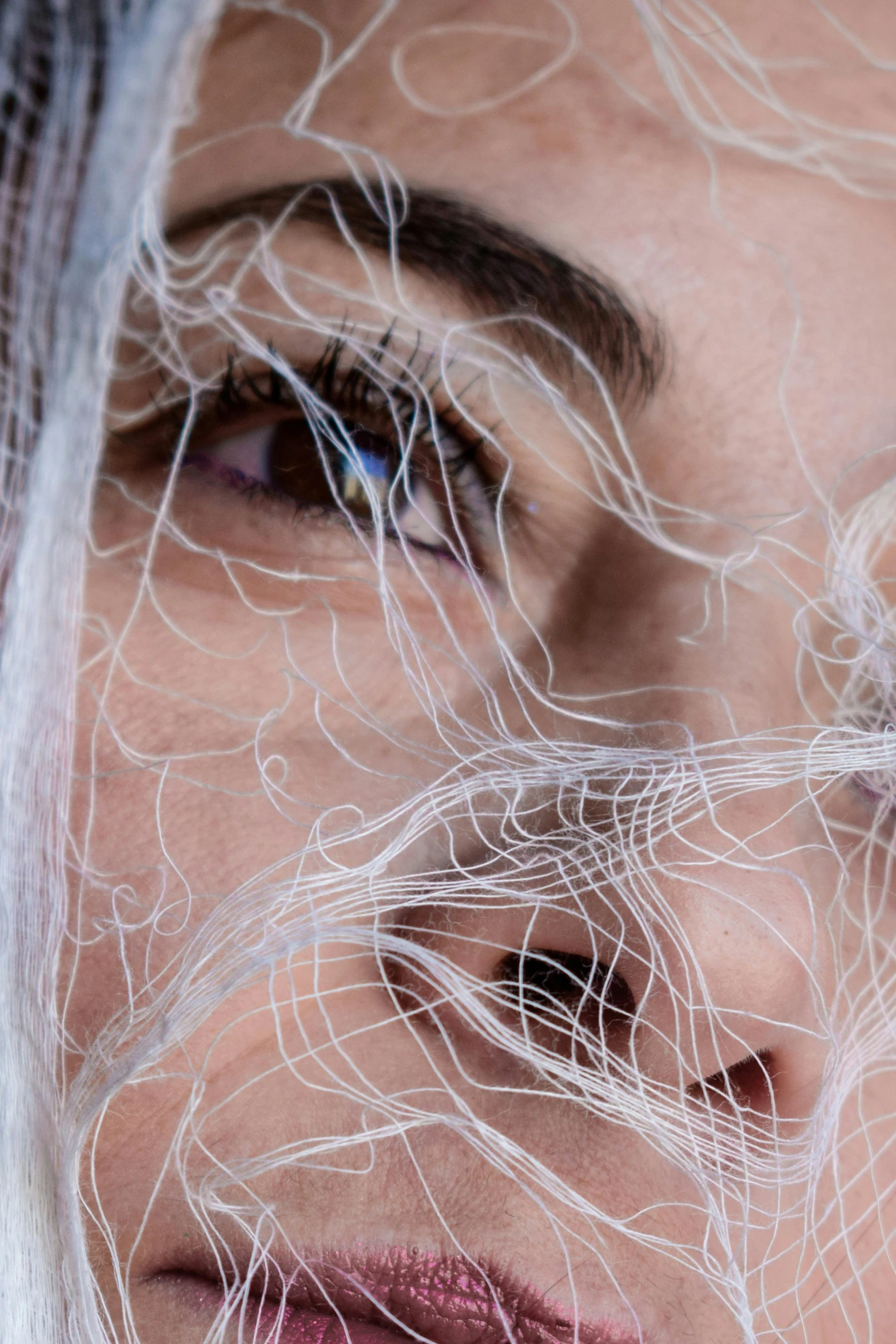 a woman with netted hair and blue eyes