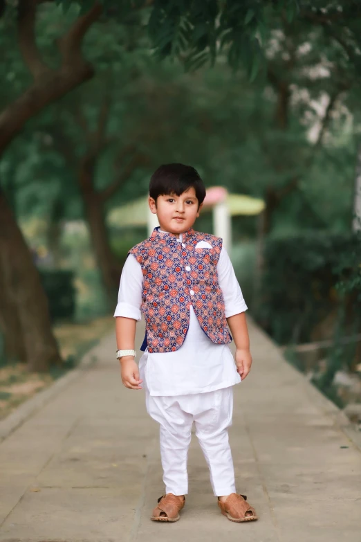 a little boy dressed up in traditional wear