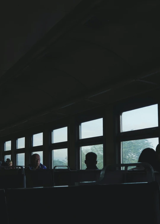 people sitting at a table with windows looking out over the city