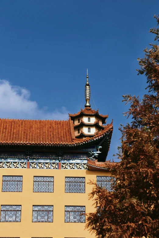 a yellow building with lots of windows and a roof