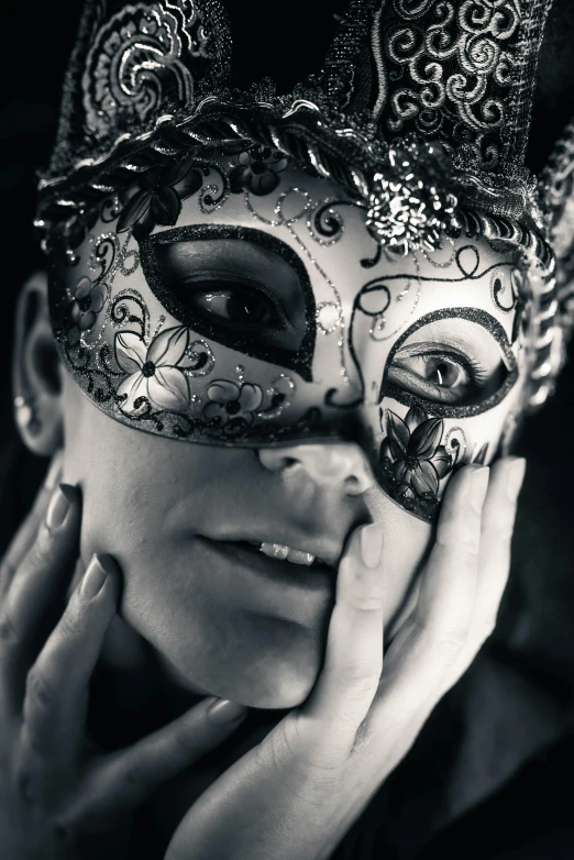 a woman wearing a mask and with her hands on her face