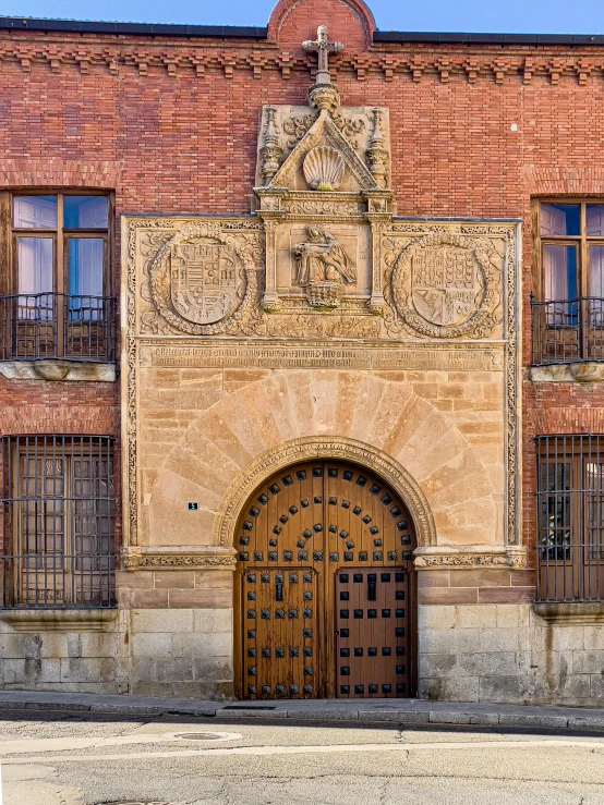 the old city building with a statue over the door