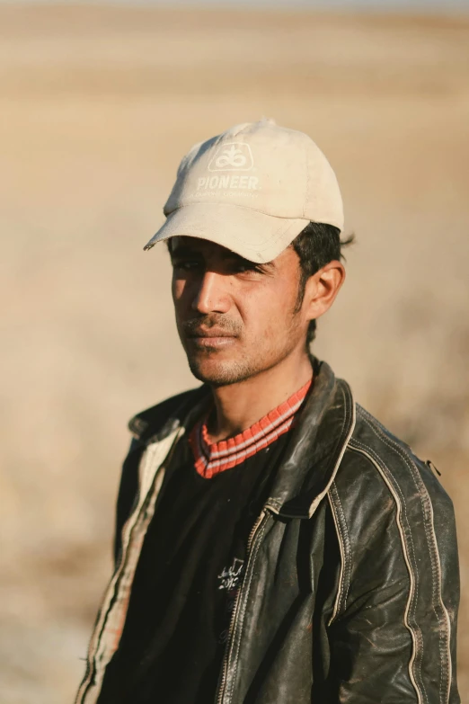 man in black jacket and hat in an open plain