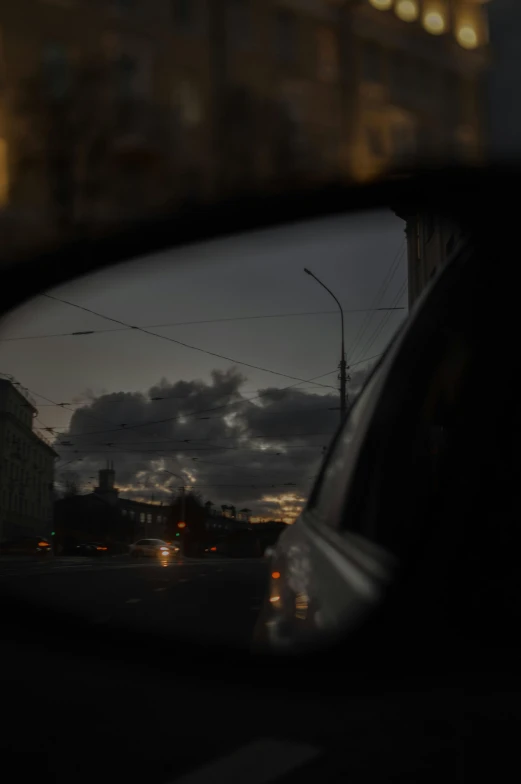 the view from a car is shown in the rear mirror