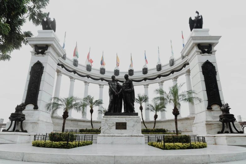 statue surrounded by decorative statues of flags and flags