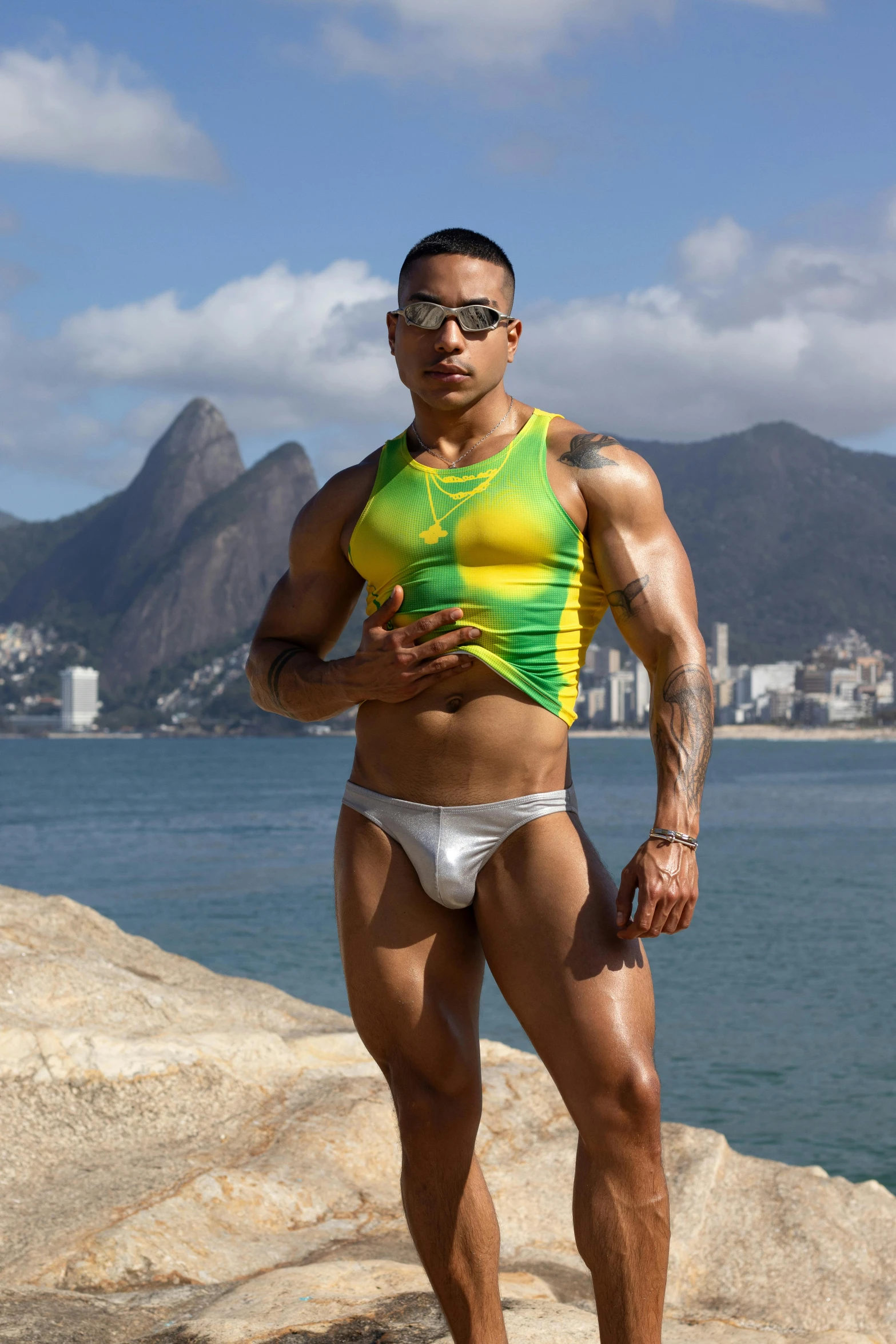 an athlete flexes his muscles while standing on the beach