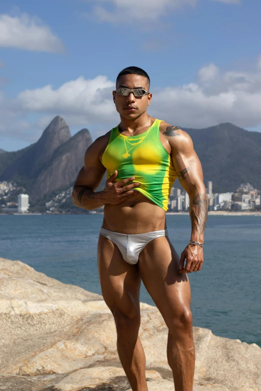 an athlete flexes his muscles while standing on the beach