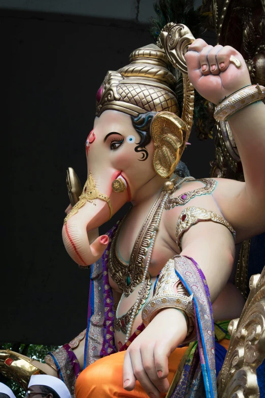 an idol is being held by a hand with a string around its mouth