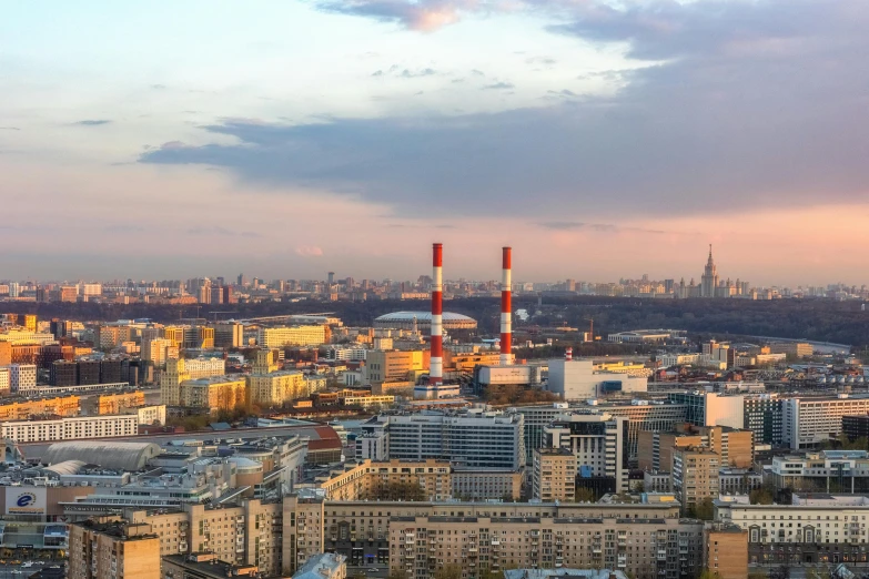 a city with very tall buildings and very cloudy sky