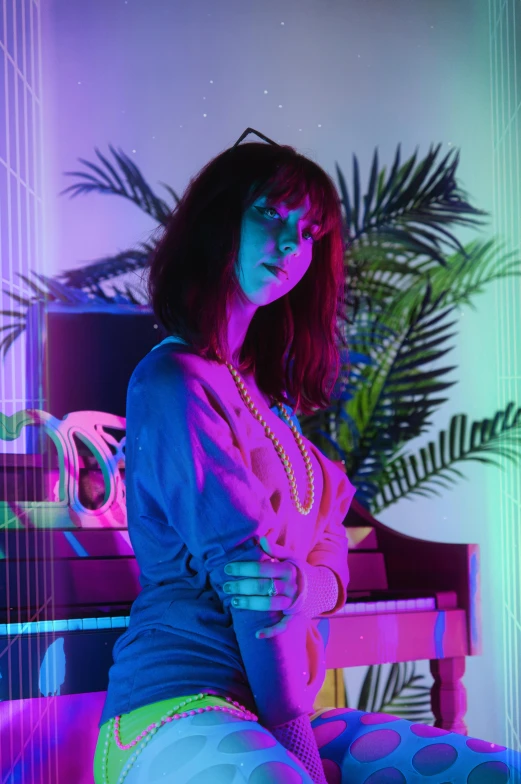a young woman sits in front of a piano with neon light