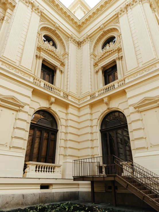 the architecture of a building with a staircase and balcony