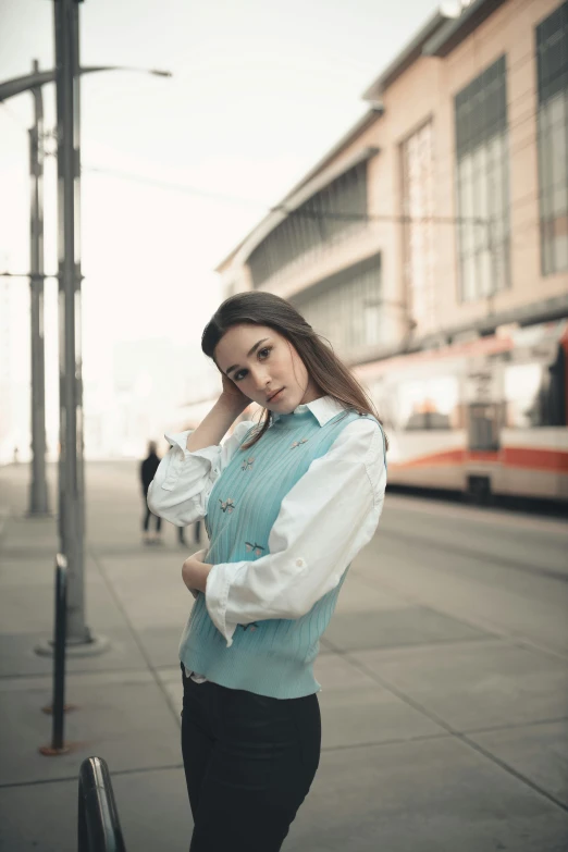 a woman standing on the side of a road