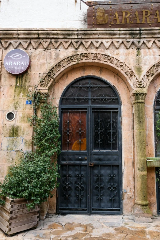 the building has arched doors that are covered with wrought iron