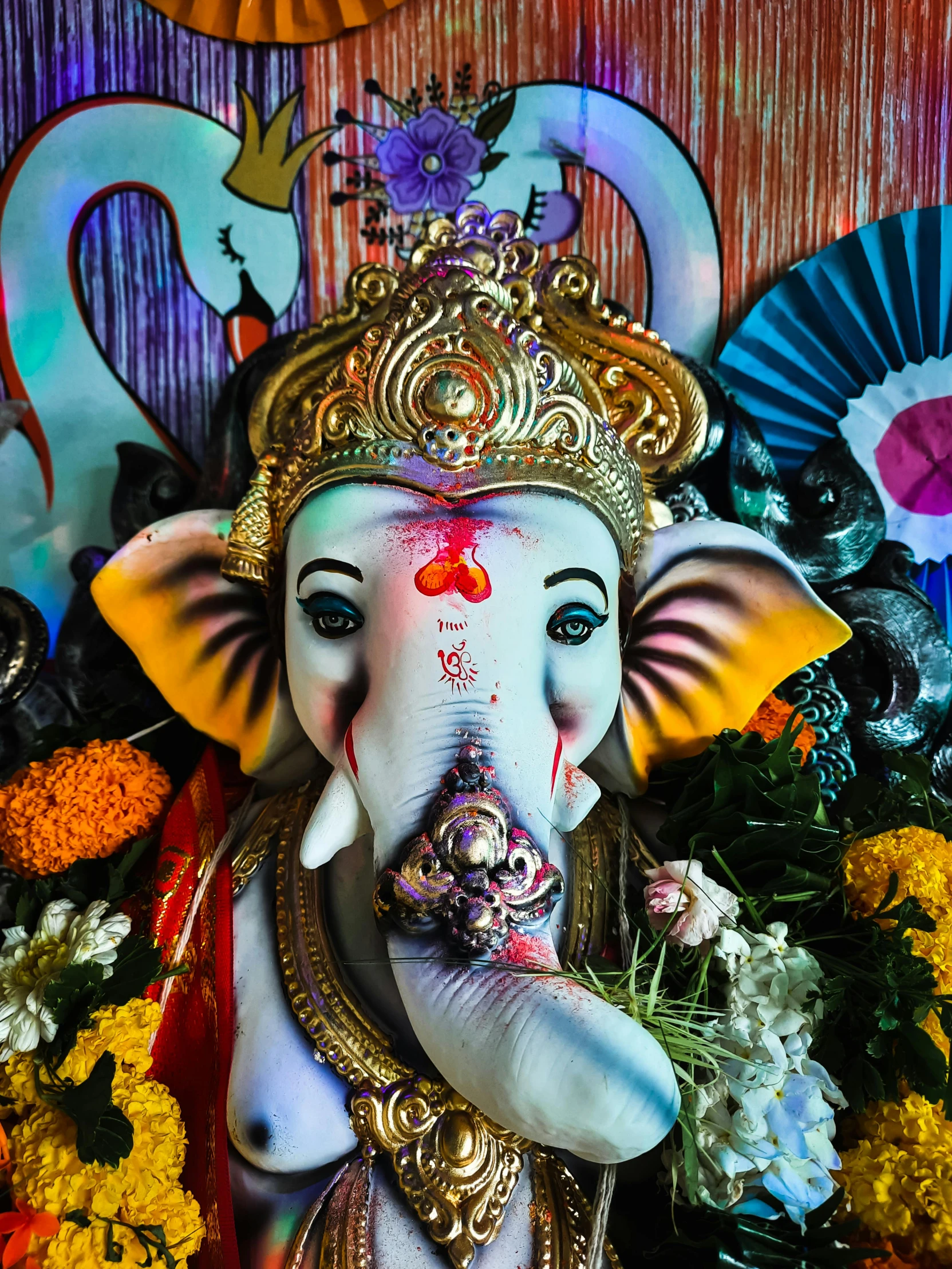 an idol is displayed with flowers and decorations