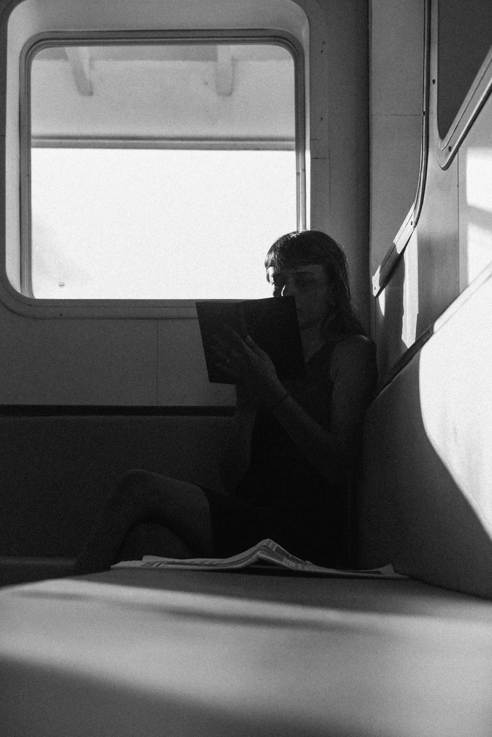 a person looking out of a window on a train