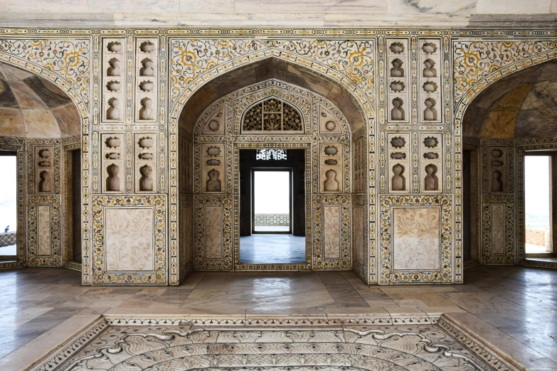 an ornate archway between two open doors inside a building