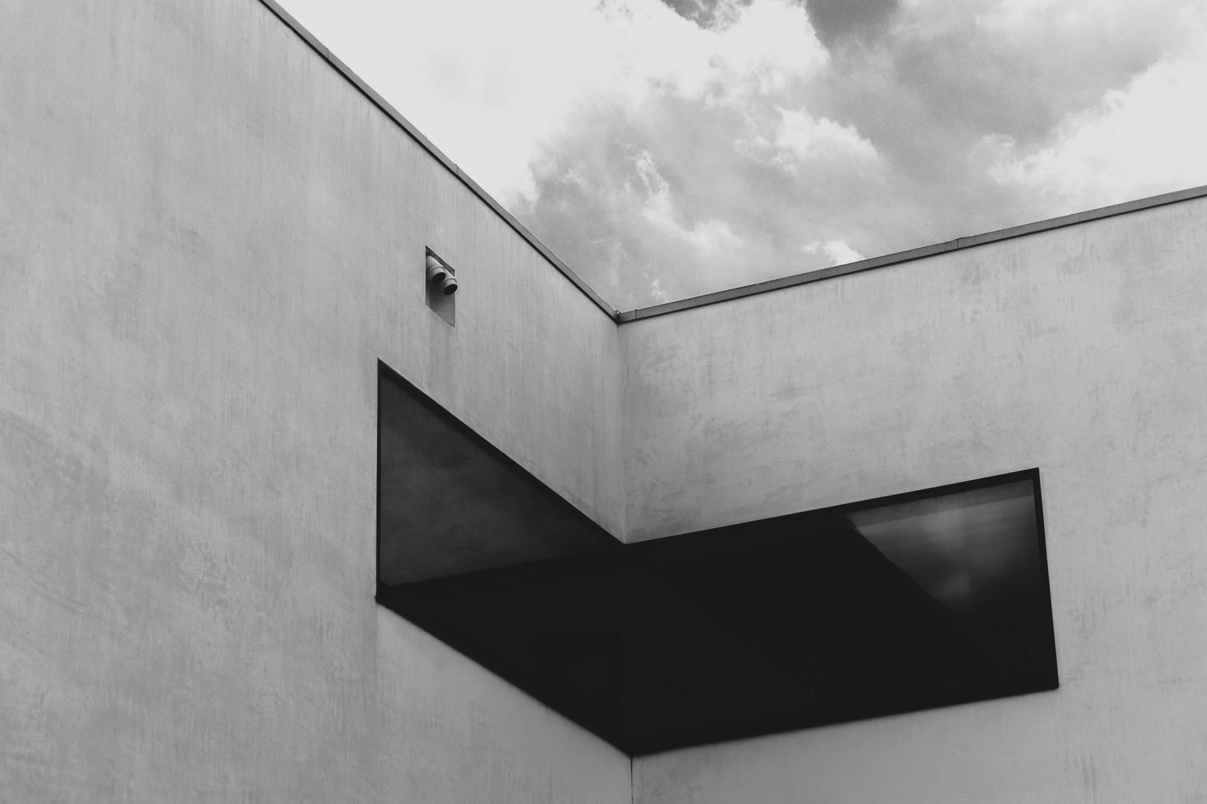 a dark and dramatic view of a building that looks out from below