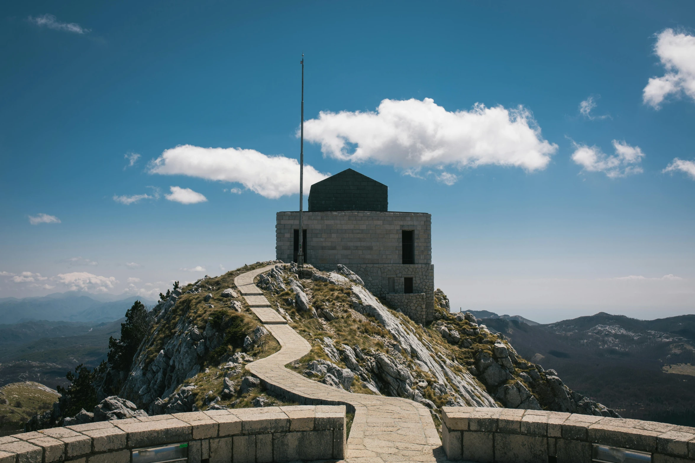 a tall rock tower sitting on top of a hill