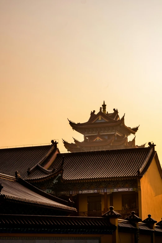 an asian building at sunset with the sky behind it