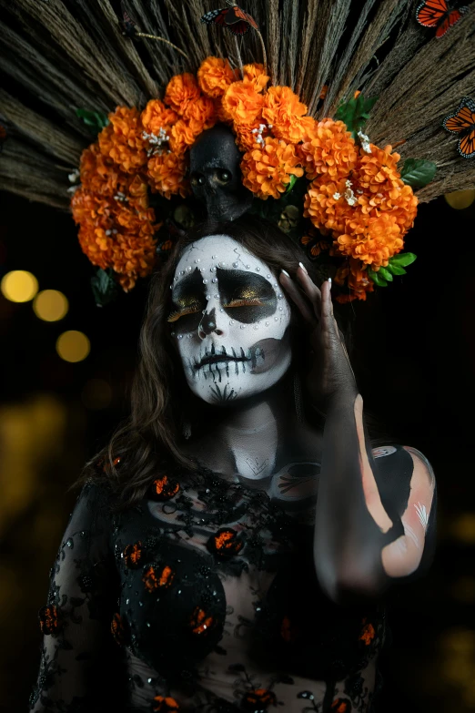 a woman with painted skulls and flowers on her head