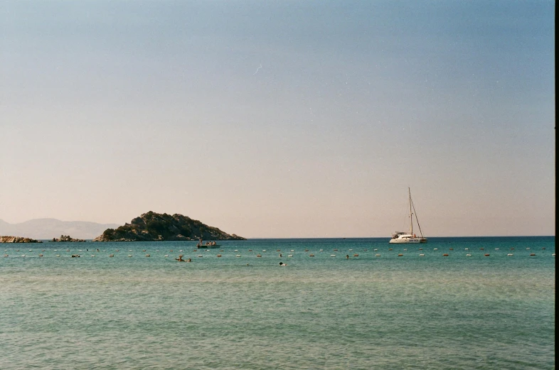 a sail boat floating in the ocean