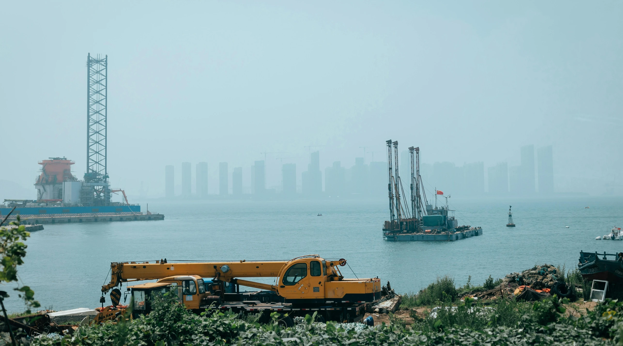 a boat floating in the water next to a tugboat